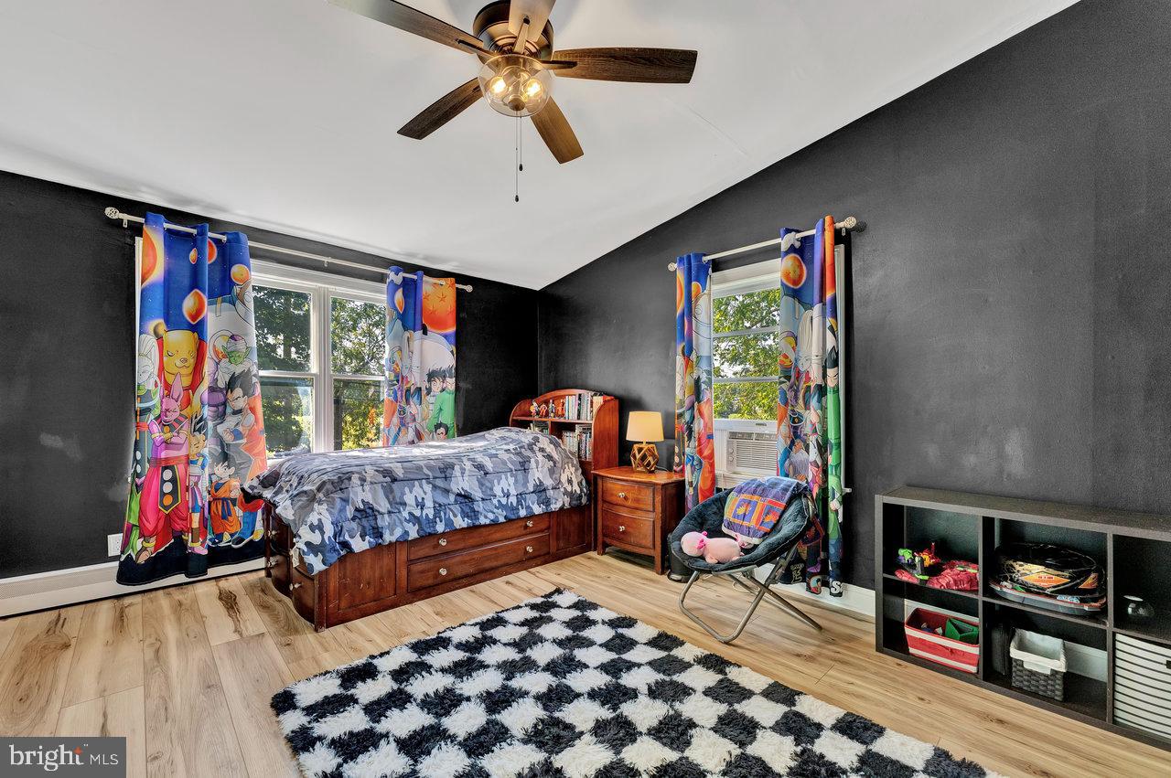 254 Friendship Road Cranbury, NJ 08512 - Photo 25 of 44 a bedroom with furniture and a flat screen tv