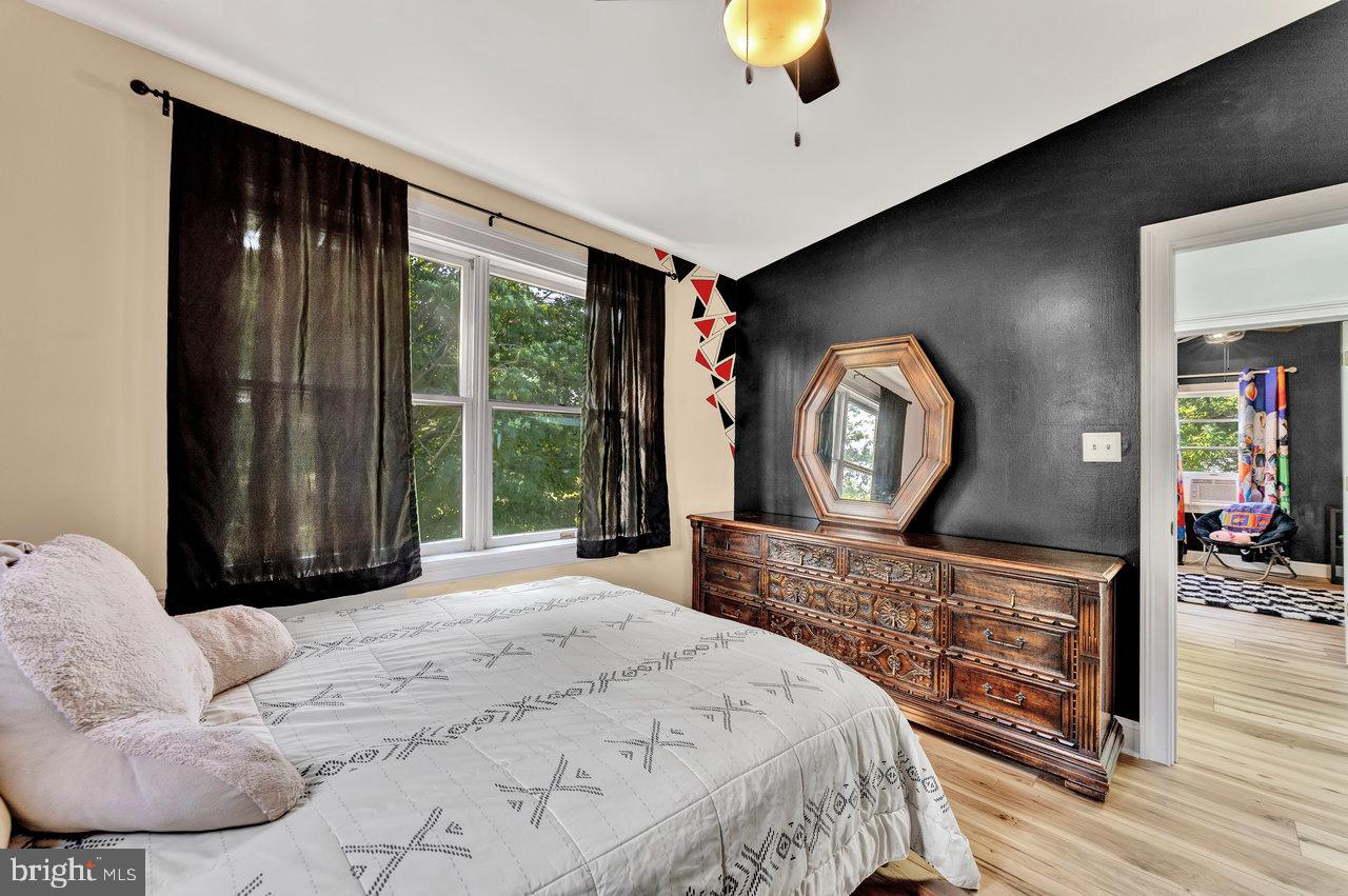 254 Friendship Road Cranbury, NJ 08512 - Photo 27 of 44 a bedroom with a bed a mirror on dresser and a large window