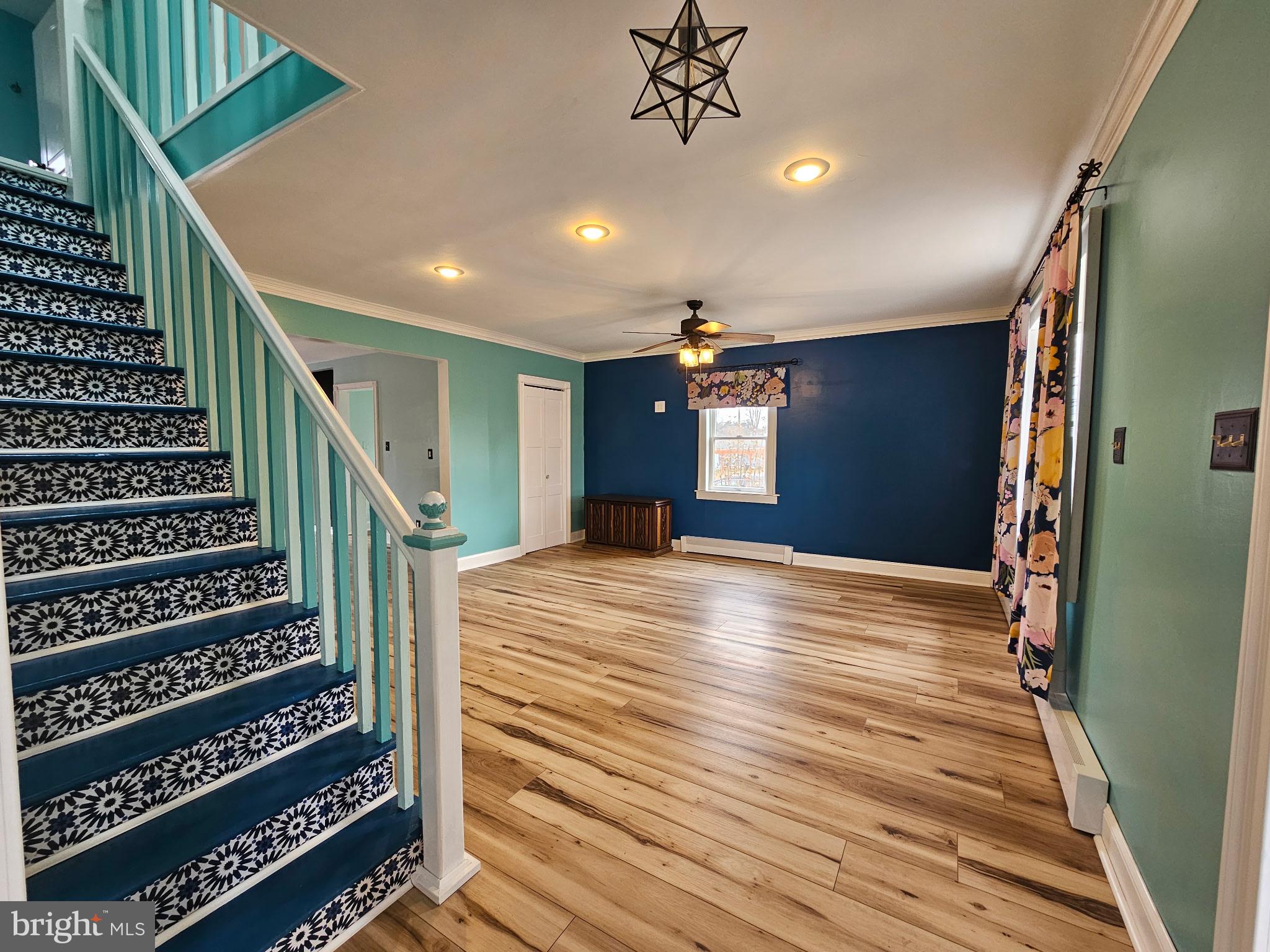254 Friendship Road Cranbury, NJ 08512 - Photo 3 of 44 a view of a hallway with wooden floor and staircase