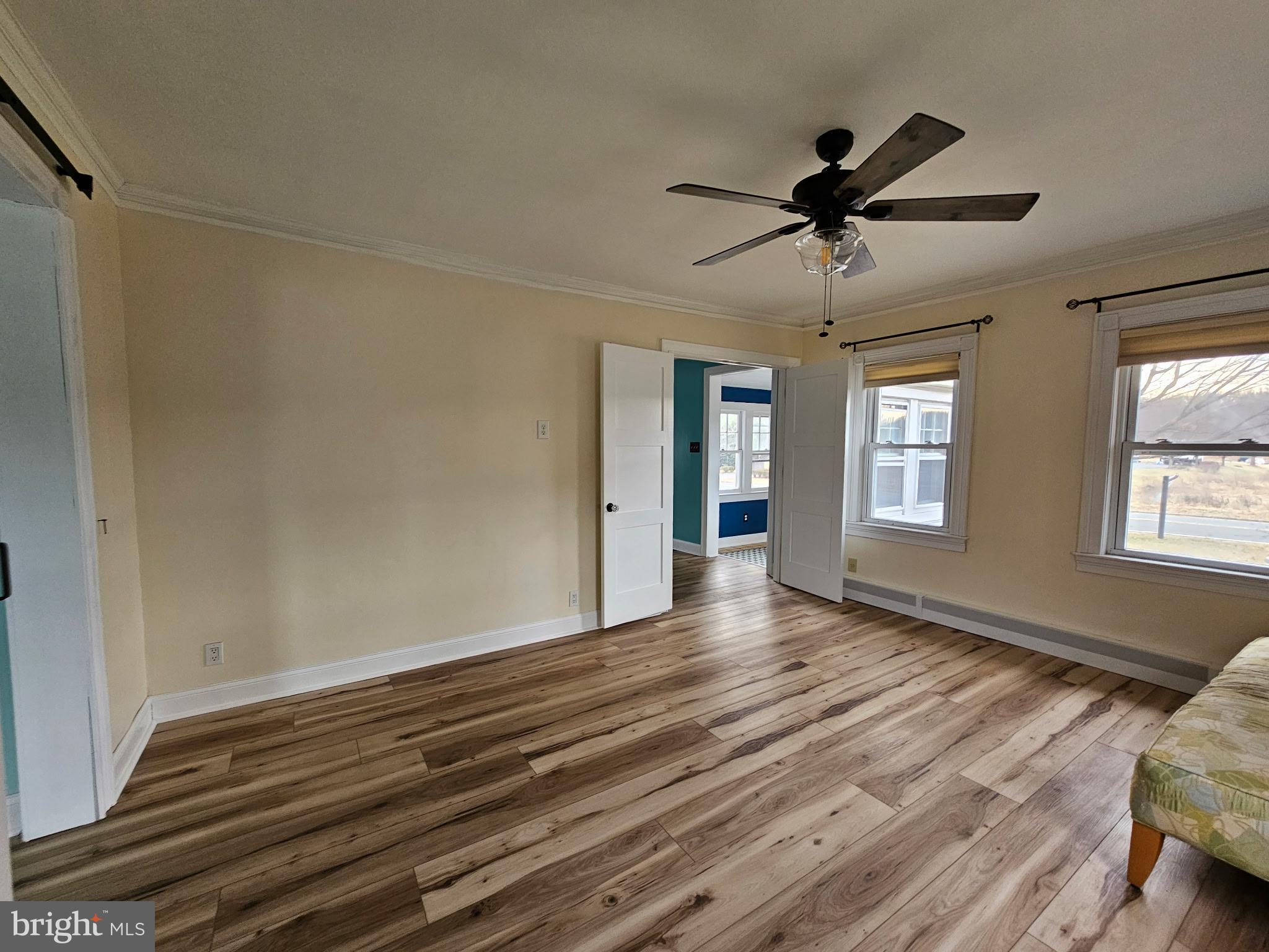 254 Friendship Road Cranbury, NJ 08512 - Photo 5 of 44 a view of an empty room with wooden floor and a window