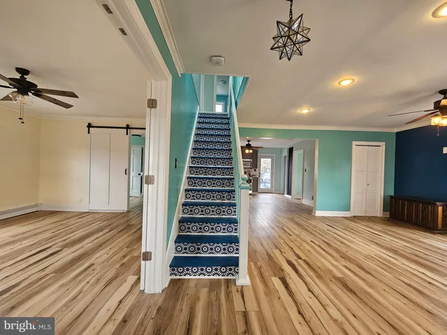 a view of a room with wooden floor and stairs