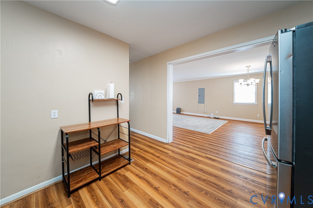 26746 Oxford Road Ruther Glen, VA 22546 - Photo 11 of 25 a view of a hallway with wooden floor and furniture