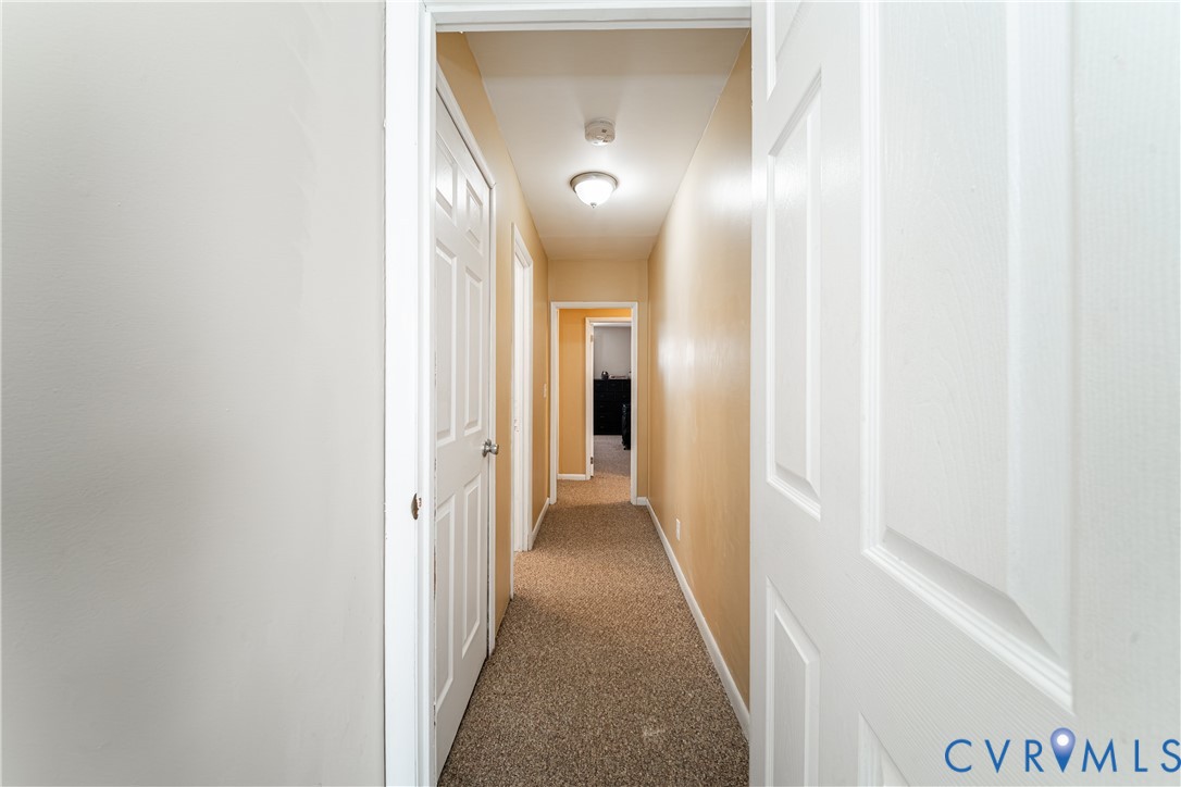 26746 Oxford Road Ruther Glen, VA 22546 - Photo 23 of 25 a view of a hallway with wooden floor
