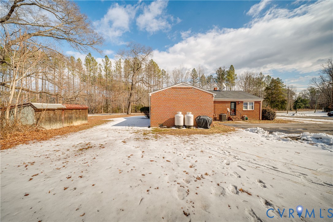 26746 Oxford Road Ruther Glen, VA 22546 - Photo 24 of 25 a view of a backyard with a barbeque and wooden fence