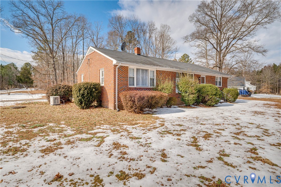 26746 Oxford Road Ruther Glen, VA 22546 - Photo 3 of 25 a front view of a house with a yard and trees