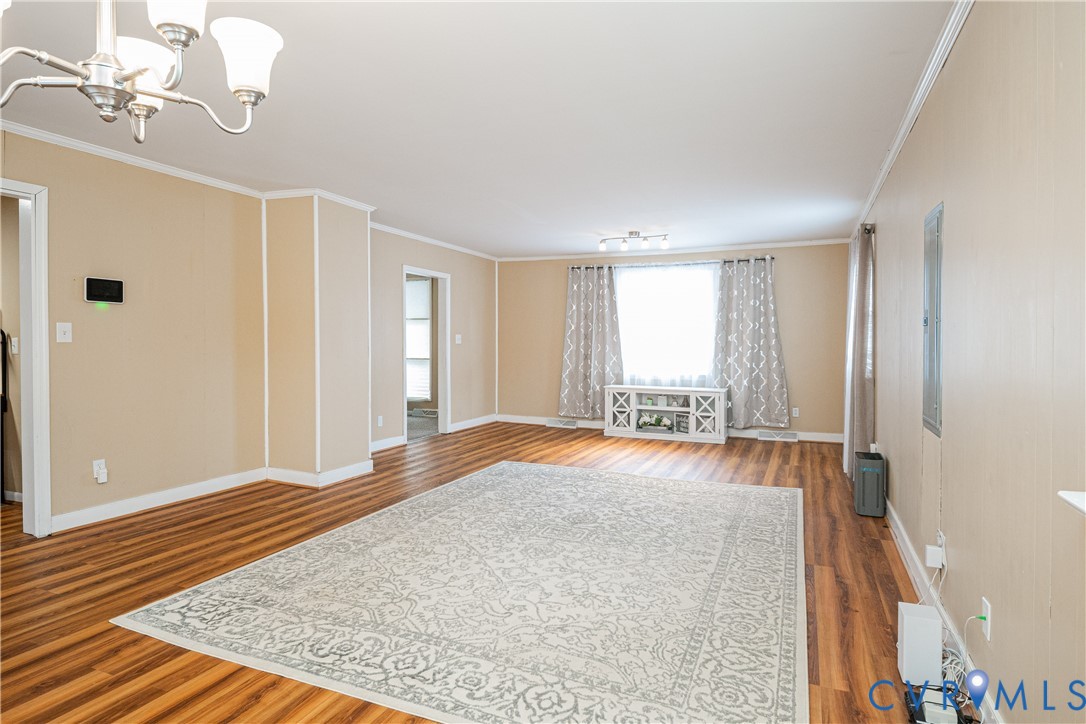 26746 Oxford Road Ruther Glen, VA 22546 - Photo 6 of 25 a view of empty room with wooden floor and fan