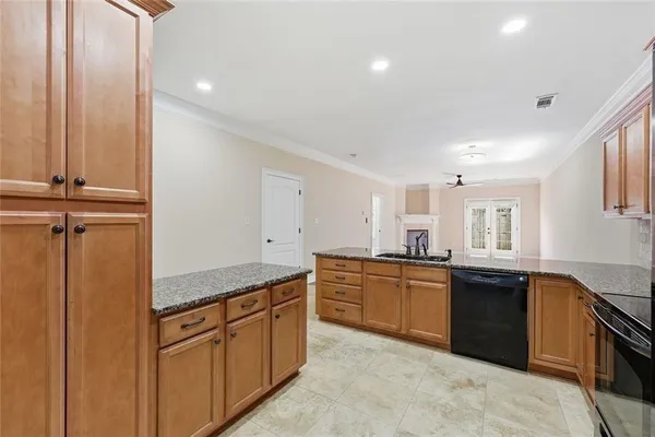 a kitchen with stainless steel appliances kitchen island granite countertop a stove a sink and a microwave