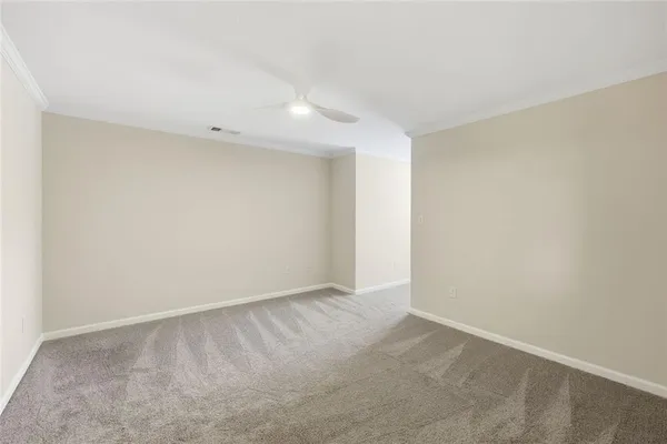 a view of walk in closet with empty racks