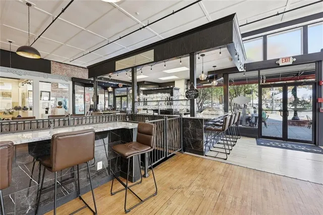 a view of a patio with table and chairs under an umbrella