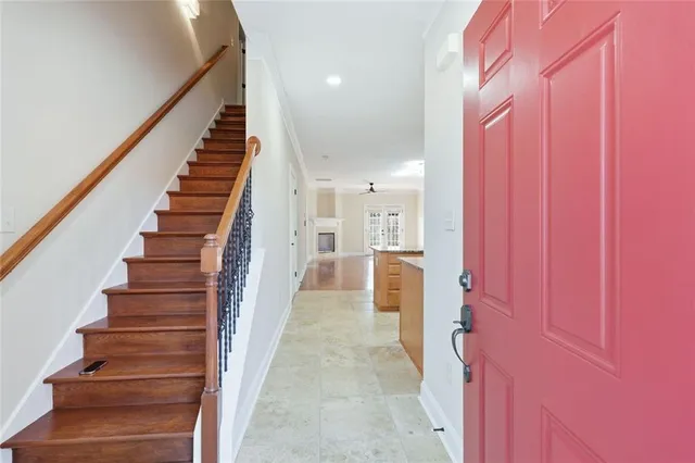 a view of staircase with wooden floor and white walls