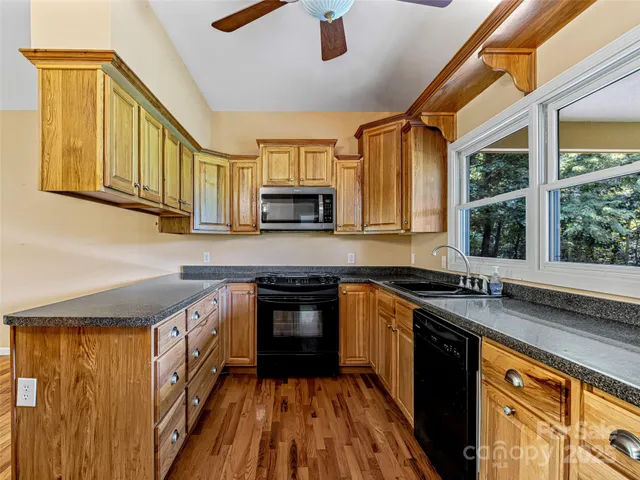a kitchen with a sink stove and microwave
