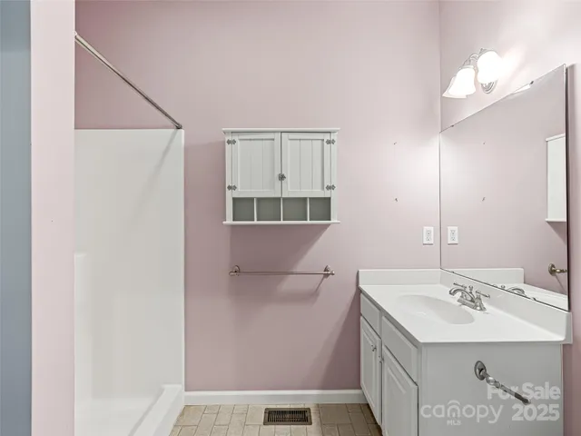 a spacious bedroom with a large bed and a large window