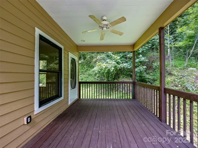a view of a entryway door wooden floor and a floor to ceiling window