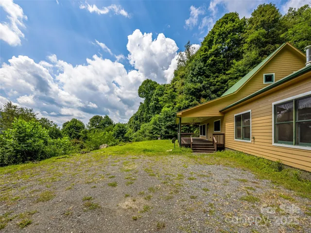a backyard of a house with table and chairs