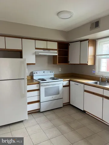 a kitchen with a stove and a refrigerator