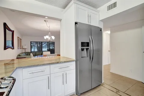 a kitchen with a refrigerator and countertop