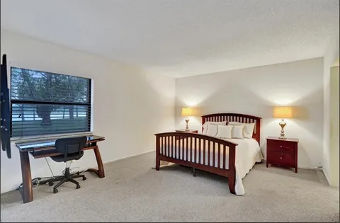 a bedroom with furniture and a window