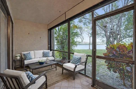 a living room with furniture and a floor to ceiling window