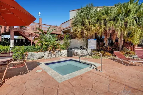 a view of backyard with swimming pool and furniture