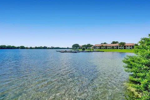 a view of a lake with houses in the back
