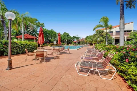 a view of a patio with table and chairs potted plants
