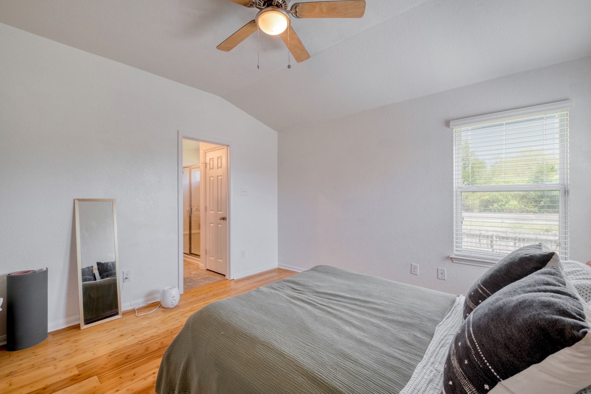 174 Falcon Drive Luling, TX 78648 - Photo 16 of 38 Primary Bedroom featuring light wood-style floors, ceiling fan, and vaulted ceiling
