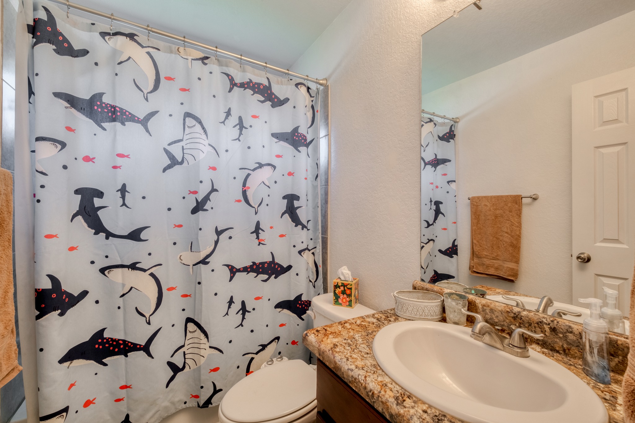 174 Falcon Drive Luling, TX 78648 - Photo 20 of 38 Bathroom featuring vanity, a shower with shower curtain, and a textured wall