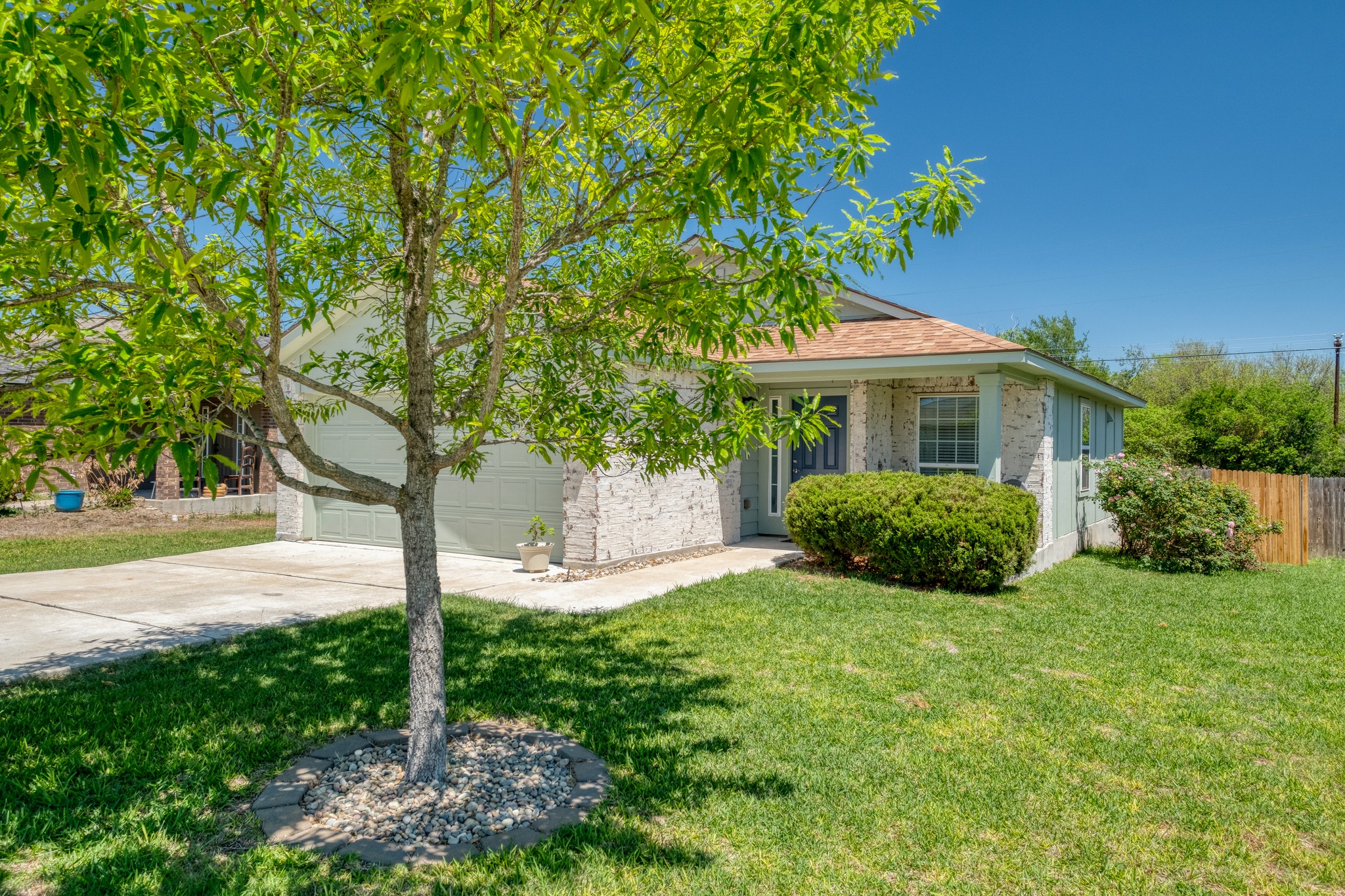 174 Falcon Drive Luling, TX 78648 - Photo 2 of 38 View of property showing natural elements featuring driveway, a garage, and brick siding