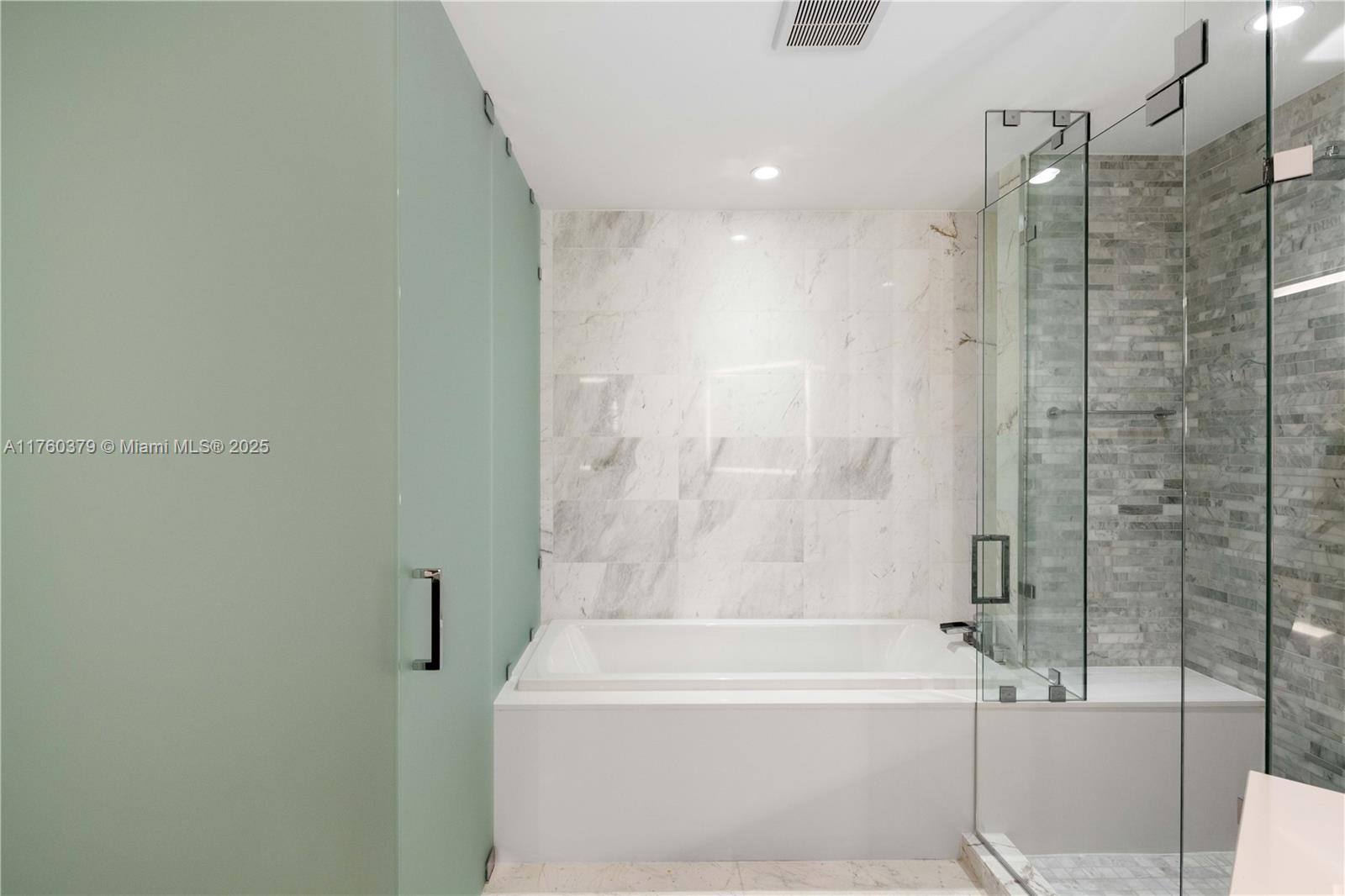 851 Northeast 1st Avenue, Unit 4203 Miami, FL 33132 - Photo 21 of 34 a bathroom with a bathtub and shower