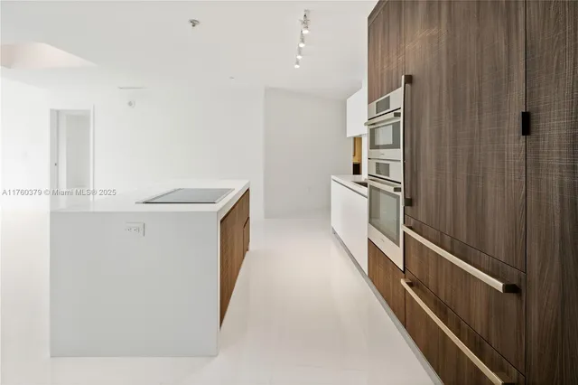 a kitchen with cabinets and stainless steel appliances
