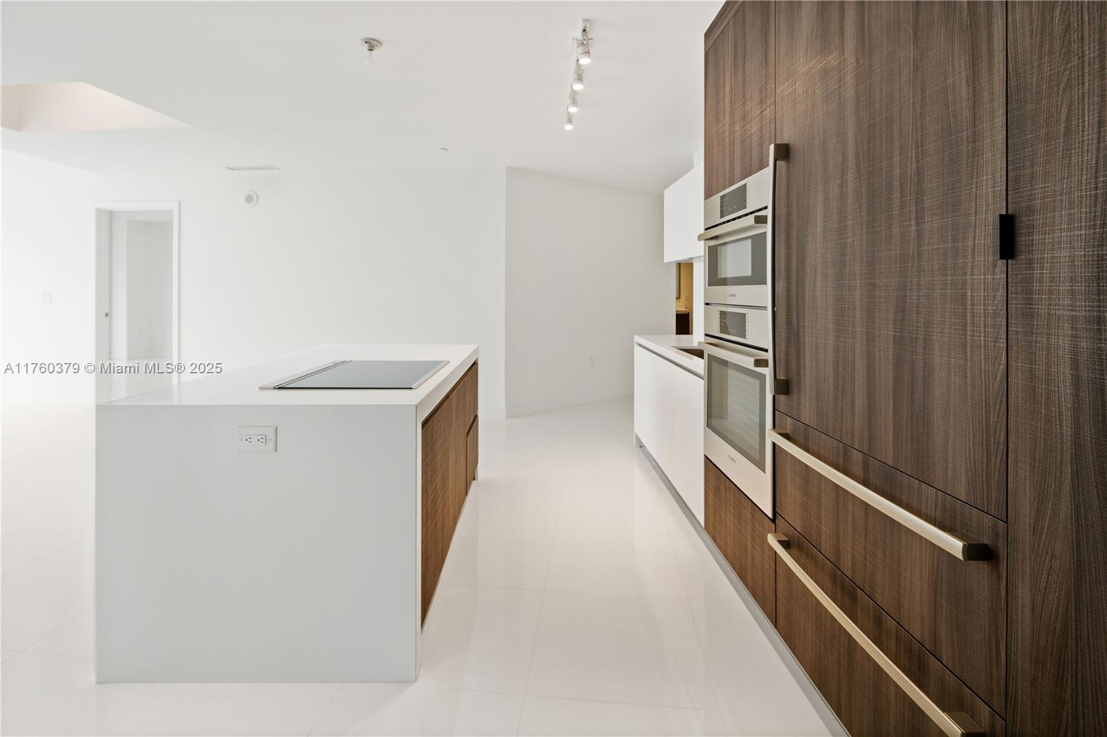 851 Northeast 1st Avenue, Unit 4203 Miami, FL 33132 - Photo 4 of 34 a kitchen with cabinets and stainless steel appliances