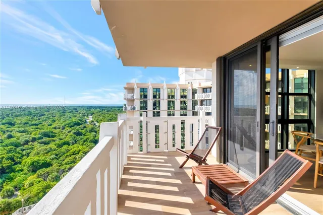 a view of balcony with wooden floor and outdoor seating