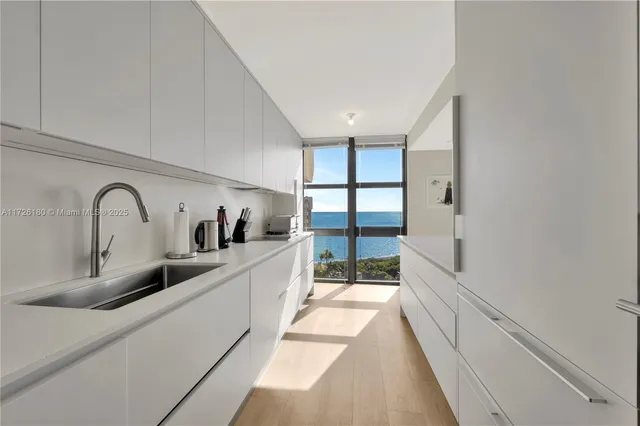 a view of a kitchen with a large window