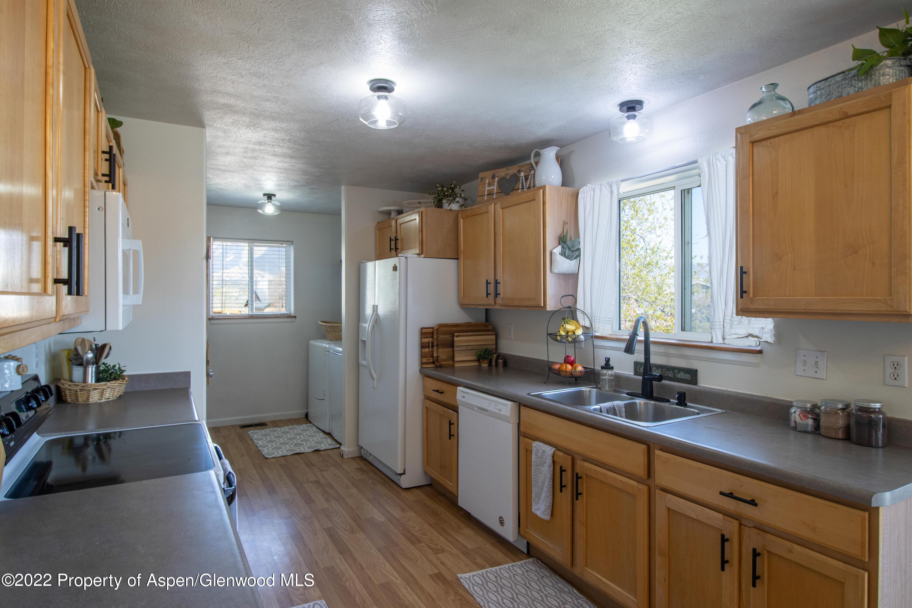 1575 Balsam Court Rifle, CO 81650 - Photo 5 of 14 a kitchen with stainless steel appliances granite countertop a sink stove and refrigerator