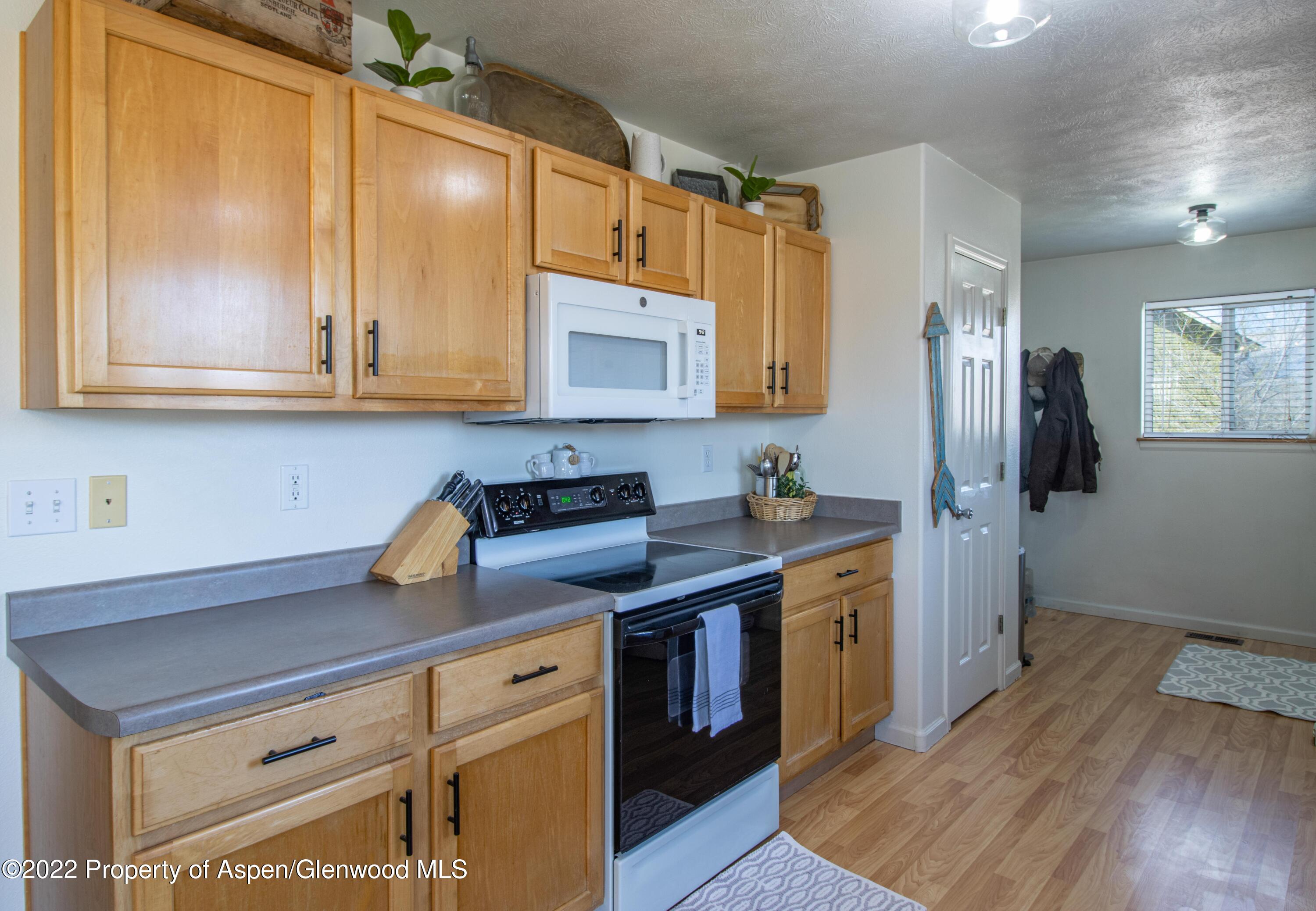 1575 Balsam Court Rifle, CO 81650 - Photo 6 of 14 a kitchen with a sink cabinets and wooden floor