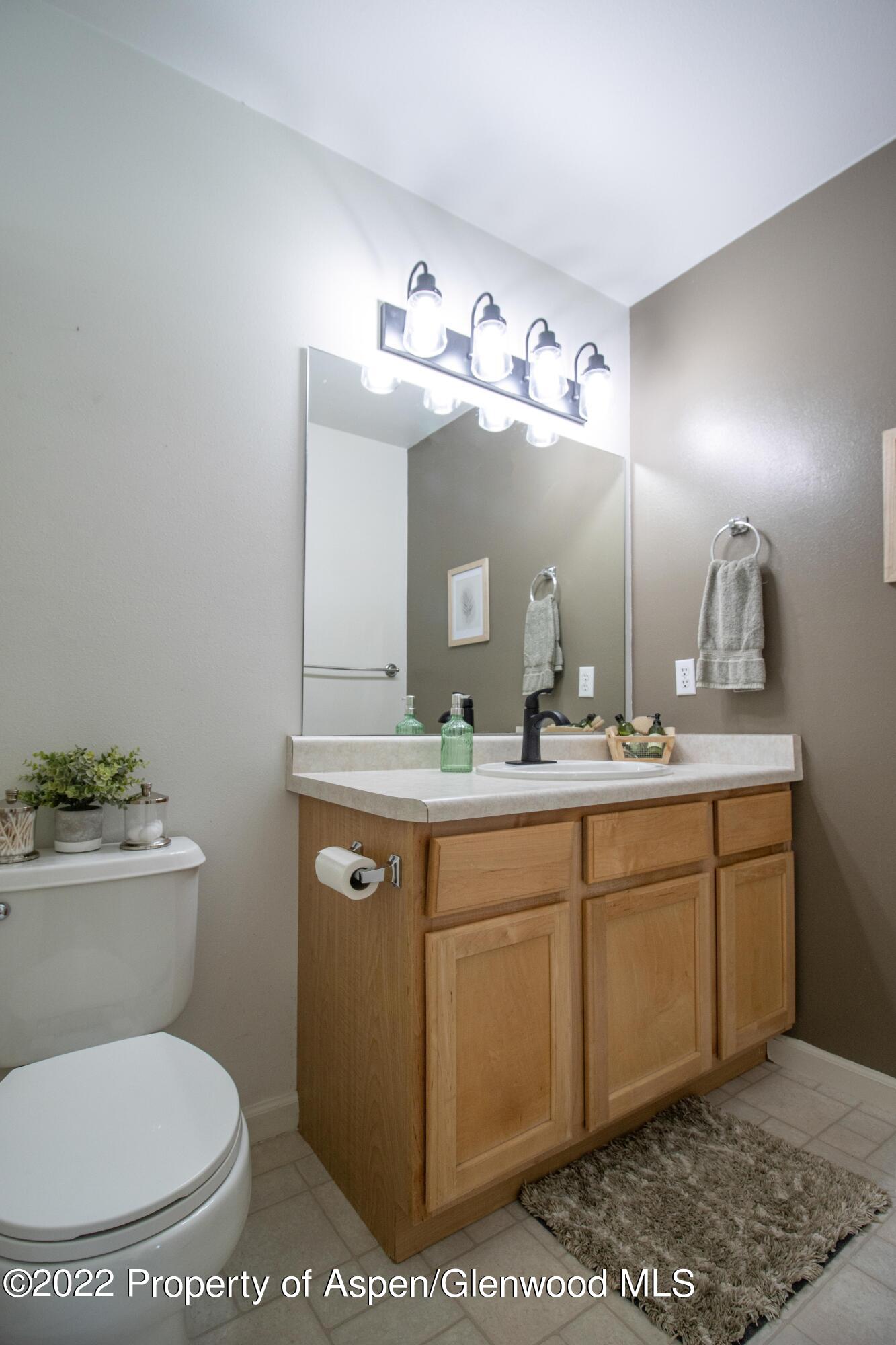 1575 Balsam Court Rifle, CO 81650 - Photo 9 of 14 a bathroom with a toilet sink and mirror