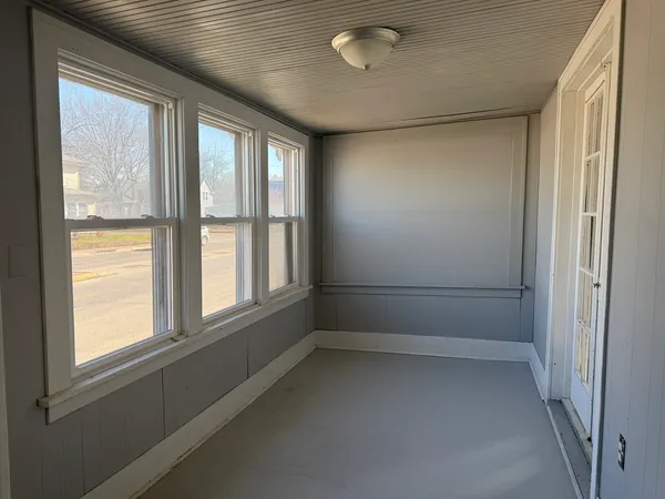 a view of empty room with large windows