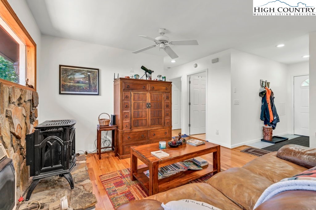 404 Running Deer Trail Boone, NC 28607 - Photo 12 of 38 a living room with furniture flat screen tv and a fireplace