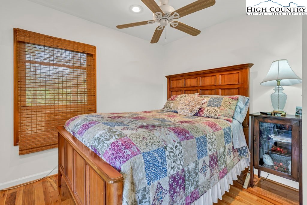404 Running Deer Trail Boone, NC 28607 - Photo 14 of 38 a bedroom with a bed and a lamp on table