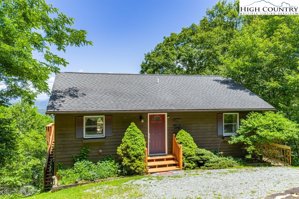 404 Running Deer Trail Boone, NC 28607 - Photo 2 of 38 a front view of a house with garden