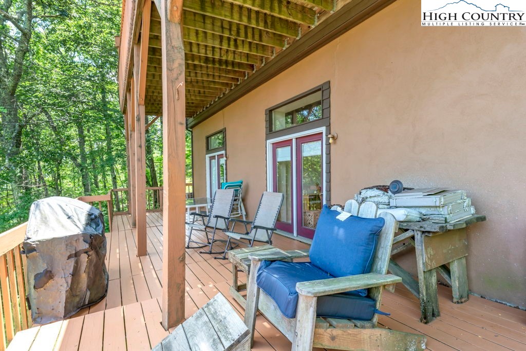 404 Running Deer Trail Boone, NC 28607 - Photo 21 of 38 a view of balcony with couch and chairs