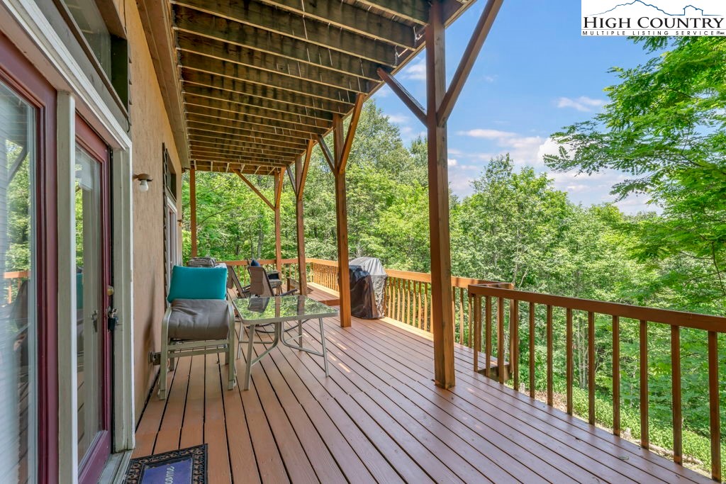 404 Running Deer Trail Boone, NC 28607 - Photo 22 of 38 a view of balcony with chairs and wooden fence