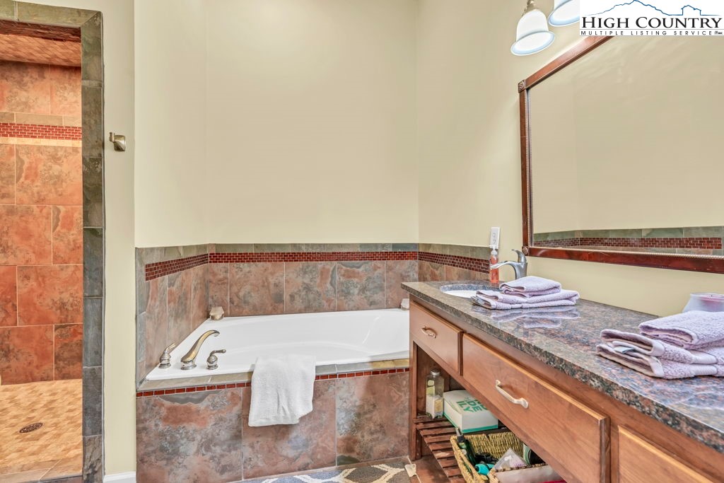 404 Running Deer Trail Boone, NC 28607 - Photo 27 of 38 a view of a balcony with two chairs and a table