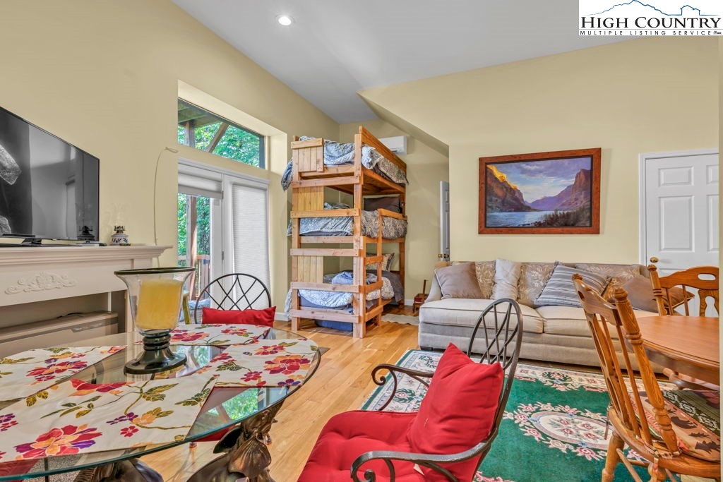404 Running Deer Trail Boone, NC 28607 - Photo 33 of 38 a living room with furniture a rug and a painting on the wall