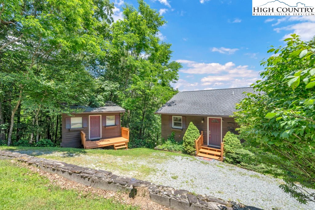 404 Running Deer Trail Boone, NC 28607 - Photo 35 of 38 a front view of a house with a garden and trees