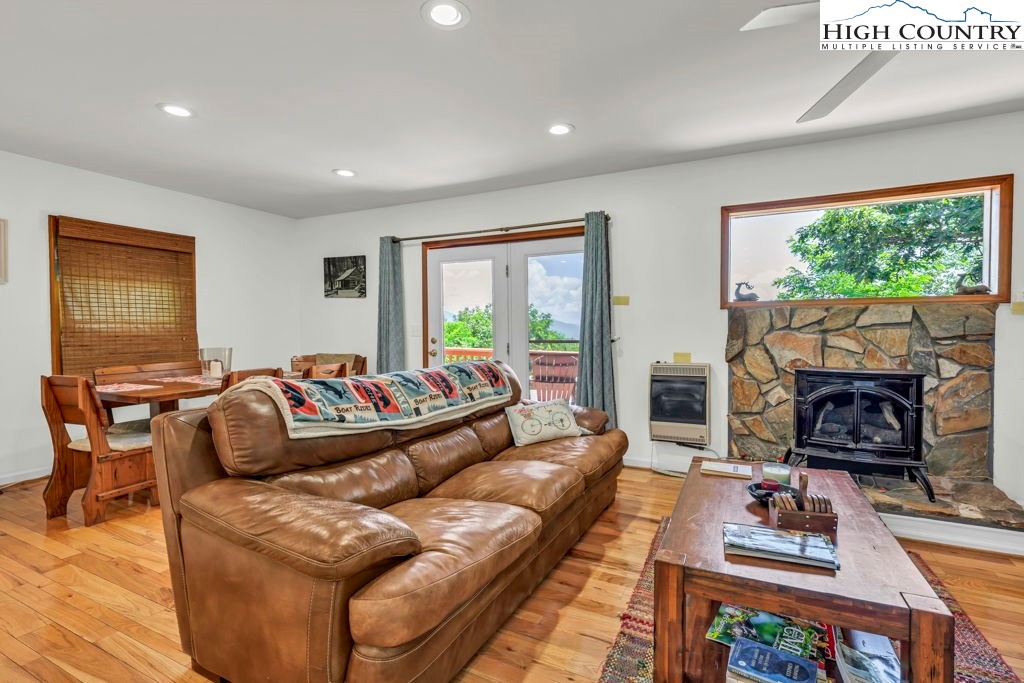 404 Running Deer Trail Boone, NC 28607 - Photo 5 of 38 a living room with furniture a large window and a fireplace