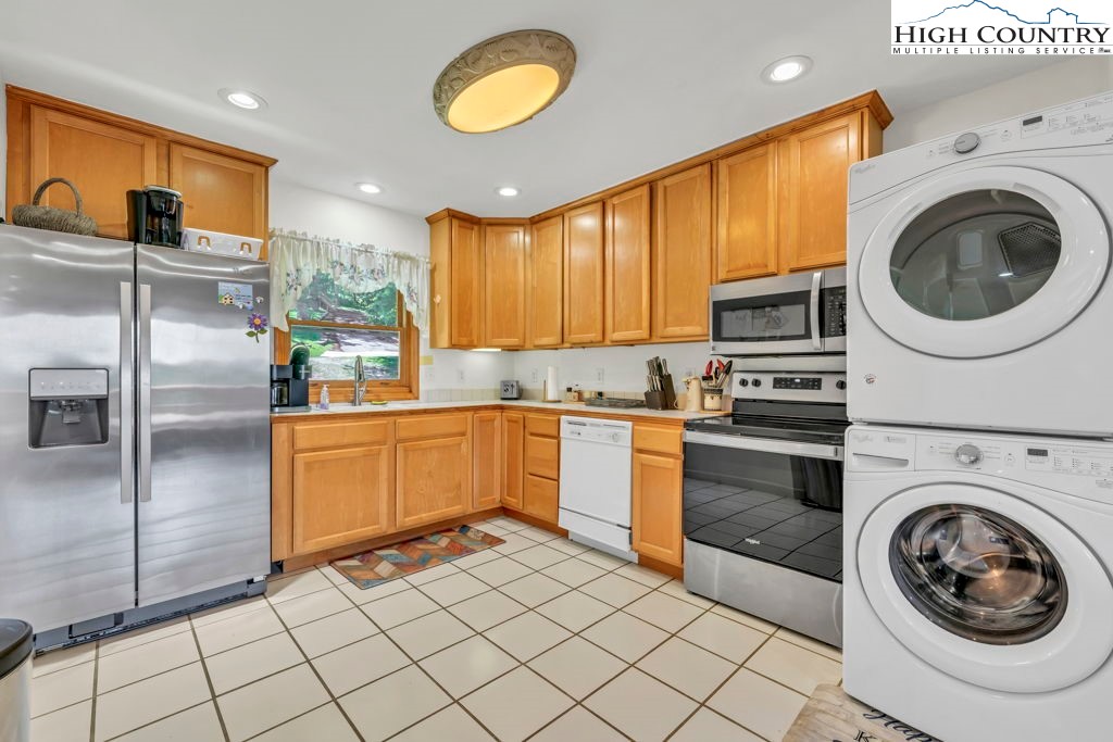 404 Running Deer Trail Boone, NC 28607 - Photo 8 of 38 a kitchen with a refrigerator sink and cabinets