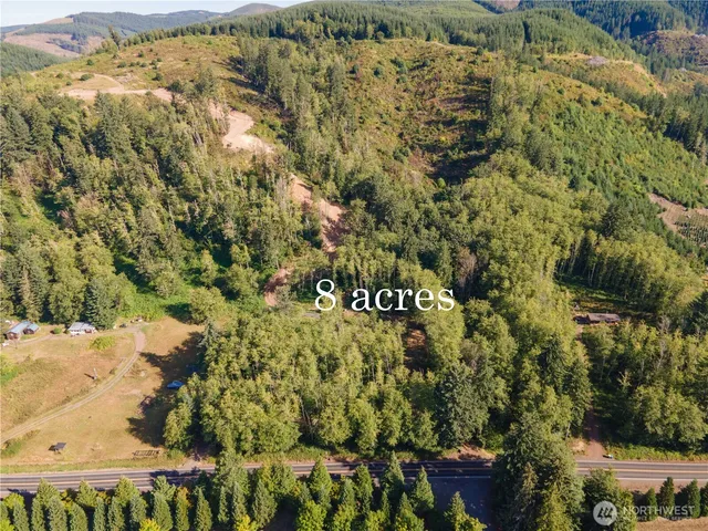 a view of a yard with wooden fence