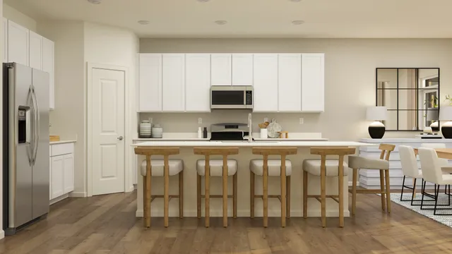 a kitchen with granite countertop a refrigerator stove top oven and cabinets