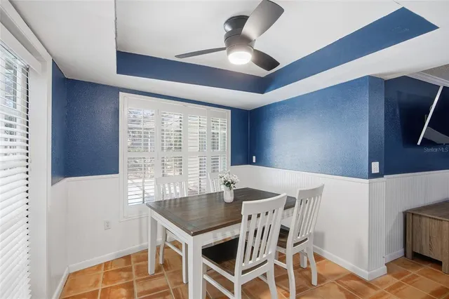 a view of a dining room with furniture and a large window